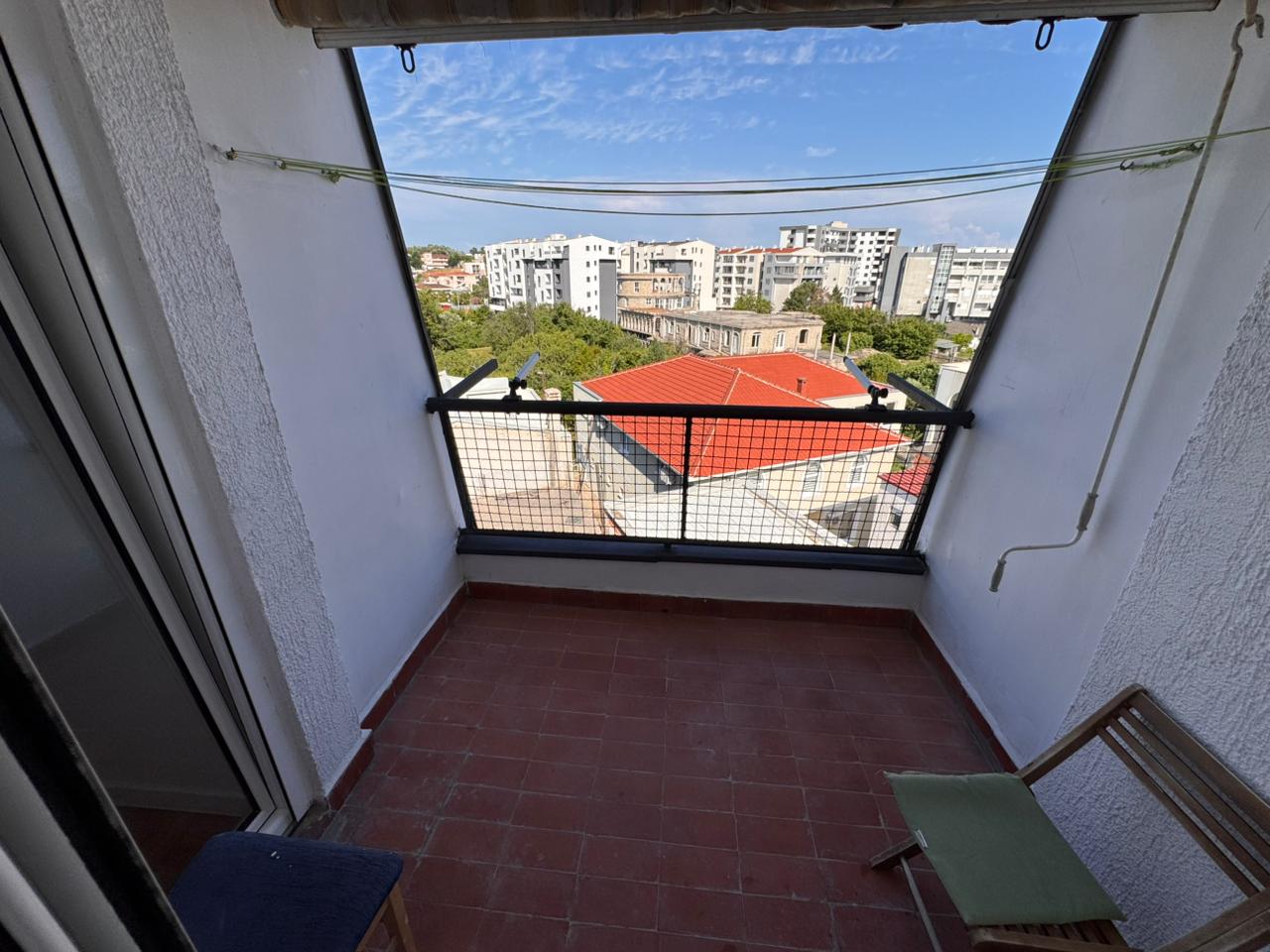 Charming Ulcinj balcony with red tiles and seating, perfect for enjoying city views—exclusive at montenegro-listings.me by Ekosphere doo.