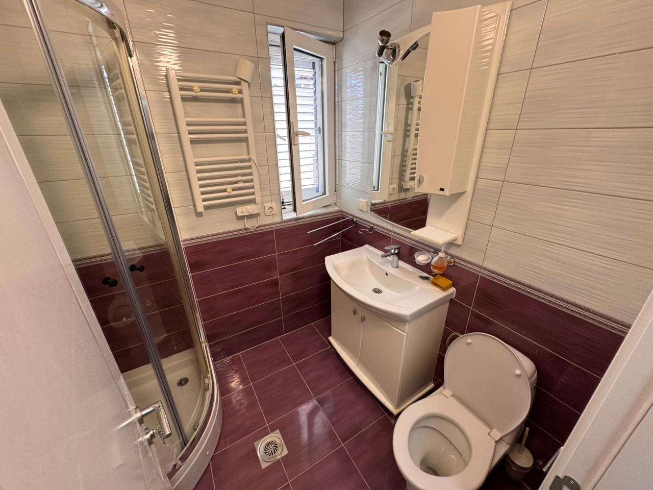 Modern Ulcinj Montenegro property bathroom with stylish tiles, glass shower, sleek fixtures—exclusive at montenegro-listings.me by ekosphere doo.