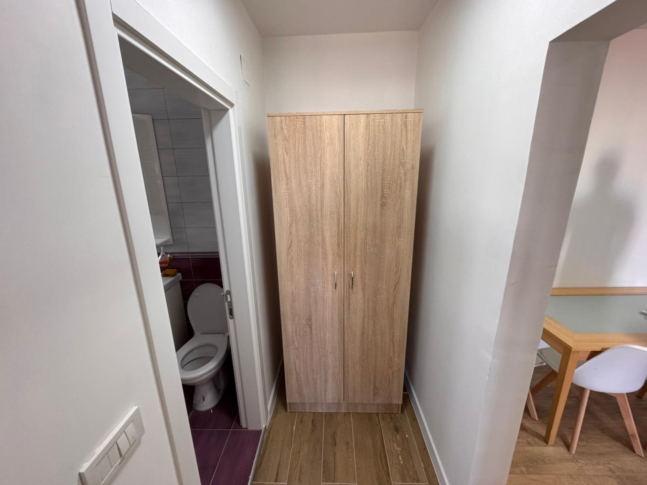 Modern Ulcinj property: hallway with wooden wardrobe, stylish dining area, and bathroom. Exclusive listing by ekosphere doo on montenegro-listings.me.