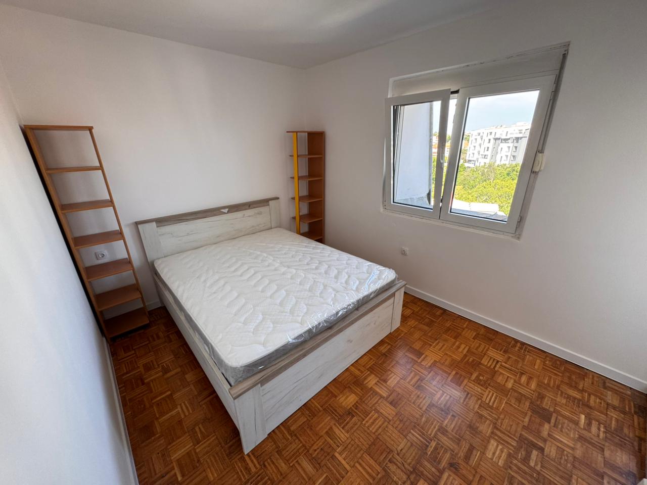 Modern Ulcinj bedroom for sale—double bed, parquet, bright window; prime investment. On montenegro-listings.me by ekosphere doo.