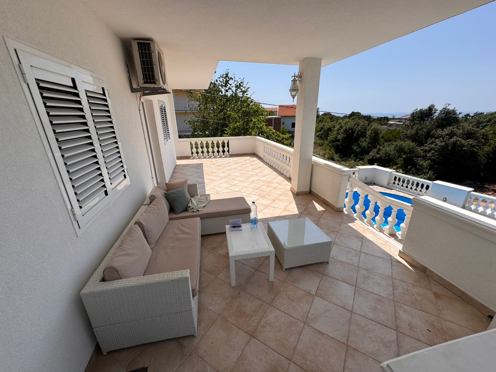 Spacious covered balcony with sea view, modern seating, and tiled floors&mdash;prime Ulcinj real estate by montenegro-listings.me/Ekosphere doo.
