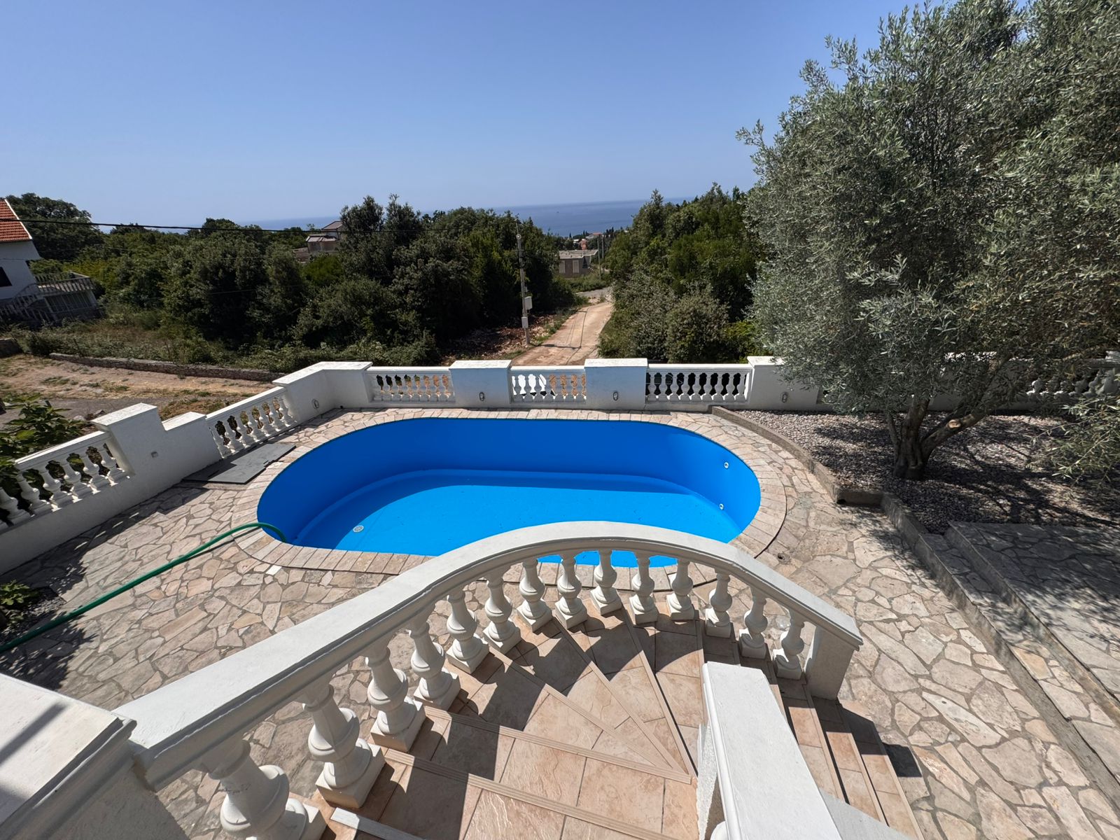 Listings for Sale - Stunning Ulcinj property: tiled stairs, private pool, stone patio & lush gardens. Invest now via montenegro-listings.me by ekosphere doo.