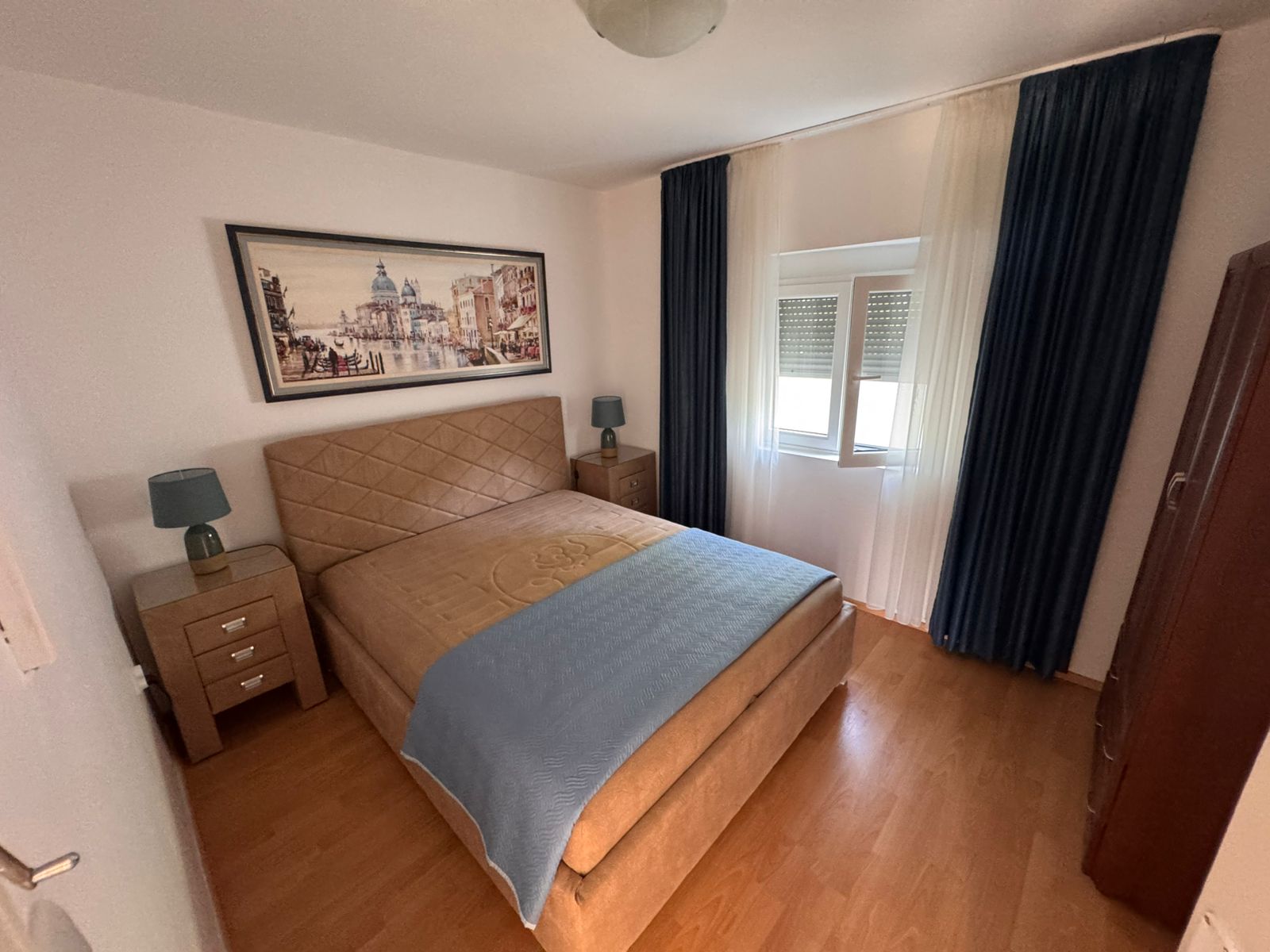 Modern Ulcinj apartment with blue-accented bedroom, wood floors, and quality finishes&mdash;invest via montenegro-listings.me by ekosphere doo.