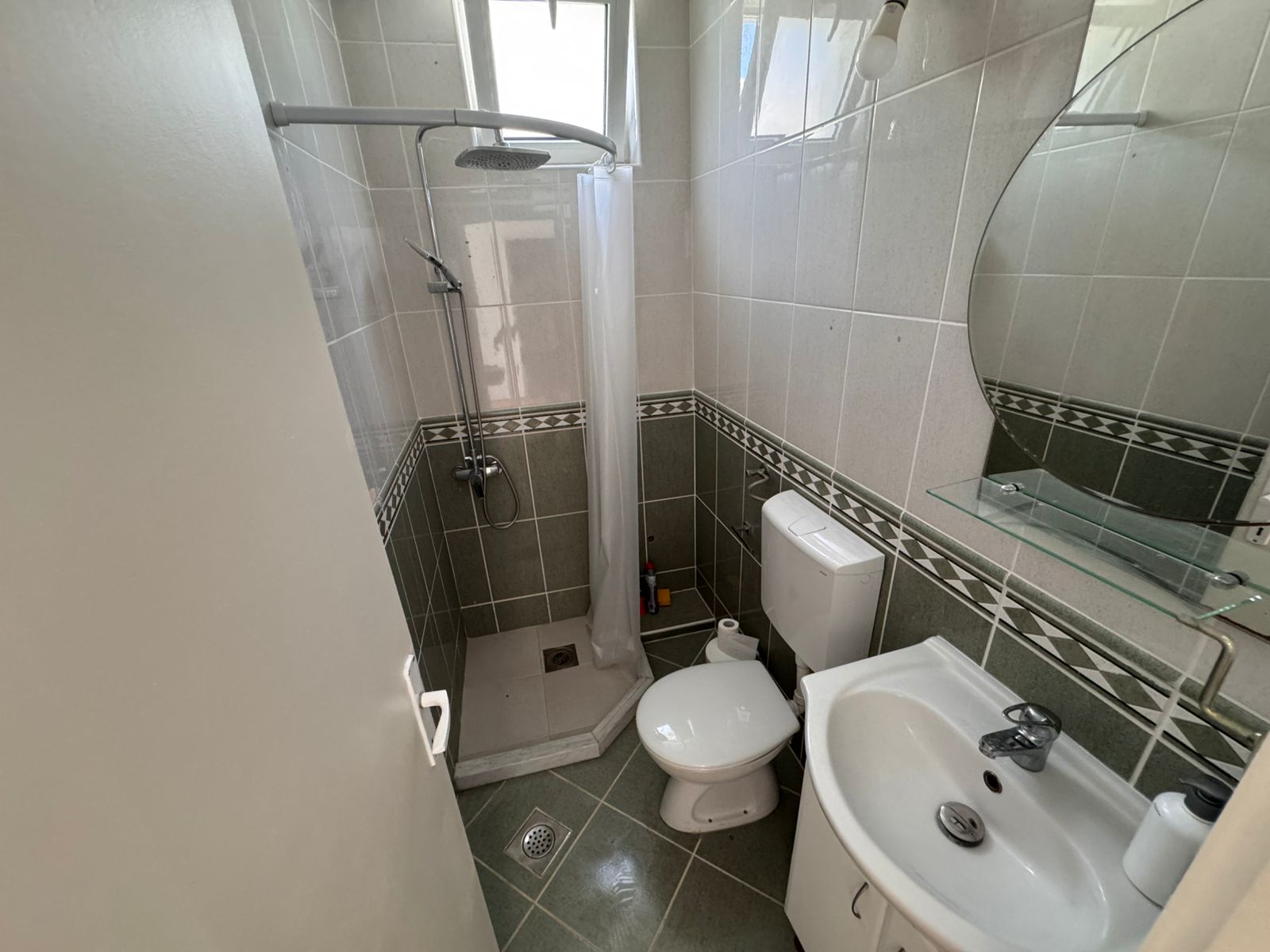 Modern small bathroom in Ulcinj property: tiled, corner shower, stylish fixtures. Invest via montenegro-listings.me by Ekosphere doo.