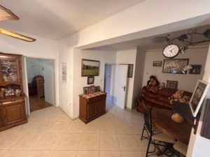 Stylish Ulcinj living room with tiled floors, wooden accents, dining area, and sofa—premium property by Ekosphere on montenegro-listings.me.