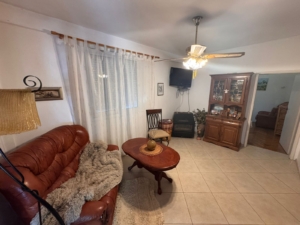Stylish Ulcinj property with brown leather sofa, TV, luxe floors—ideal investment listed on montenegro-listings.me by ekosphere doo.