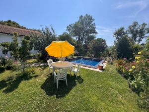 Chic outdoor oasis with pool, lush lawn, and stylish seating—ideal Ulcinj investment. Explore at montenegro-listings.me by ekosphere doo.