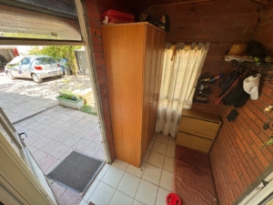 Bright entryway with tiled floors, brick accents, and storage furniture in Ulcinj home; direct driveway access. eksosphere doo project.