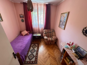 Charming Ulcinj bedroom: pink walls, single bed, armchair, window; ideal Montenegro investment on montenegro-listings.me by ekosphere doo.