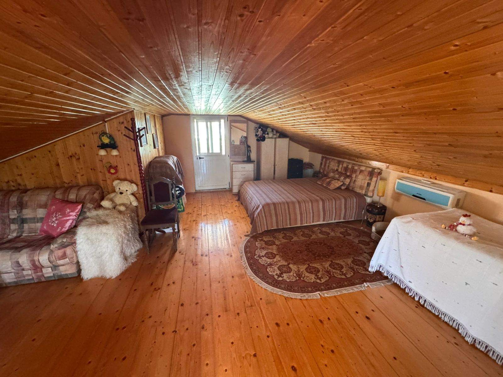 Charming attic room in Ulcinj, Montenegro with sloped wood ceiling, AC, and cozy decor&mdash;listed on montenegro-listings.me by Ekosphere DOO.