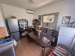 Modern kitchen-dining in Ulcinj: glass-top table, 6 chairs, appliances. Ideal Montenegro investment by Ekosphere’s listings.me.