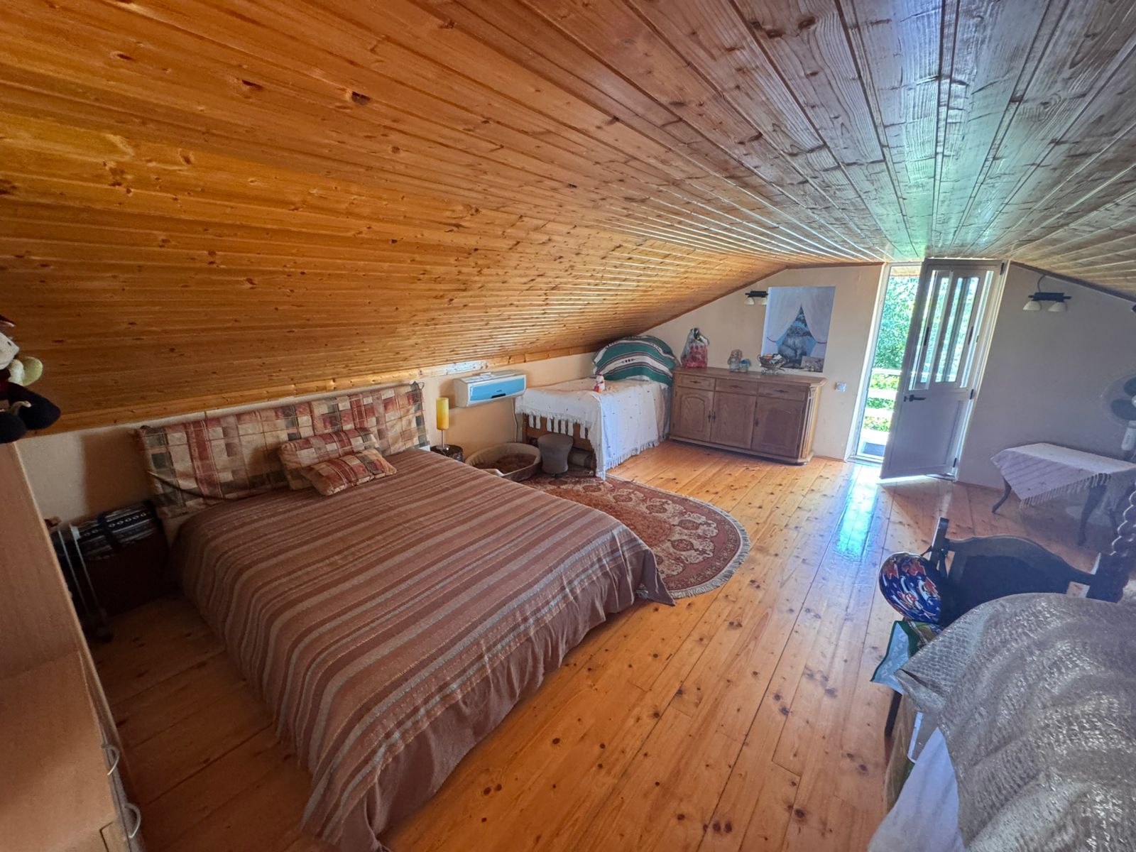 Charming Ulcinj attic bedroom with wood floors, sunlit double bed, and quality finishes&mdash;exclusive property via montenegro-listings.me by ekosphere doo.