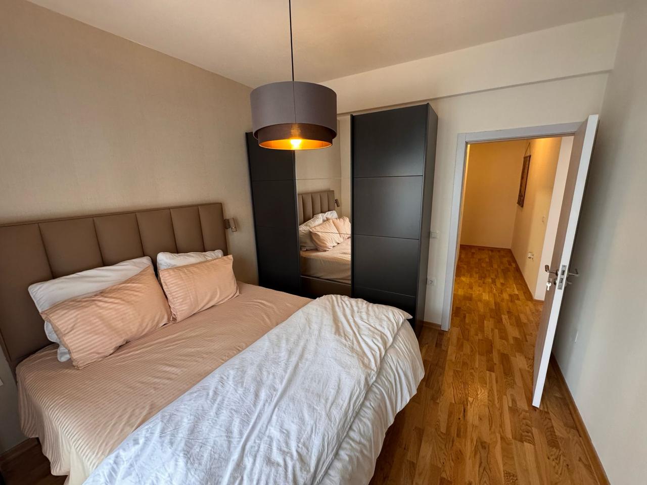 Bright Ulcinj bedroom with double bed, mirrored wardrobe; ideal real estate investment via montenegro-listings.me by Ekosphere doo.