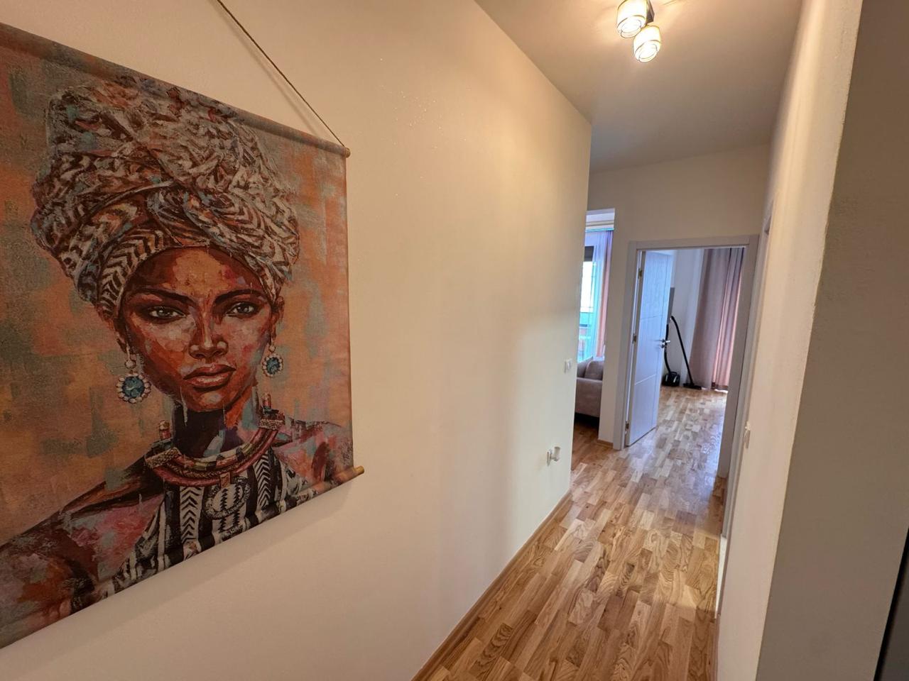 Elegant hallway with wood floors, art, and modern rooms&mdash;prime Ulcinj real estate by ekosphere doo on montenegro-listings.me.