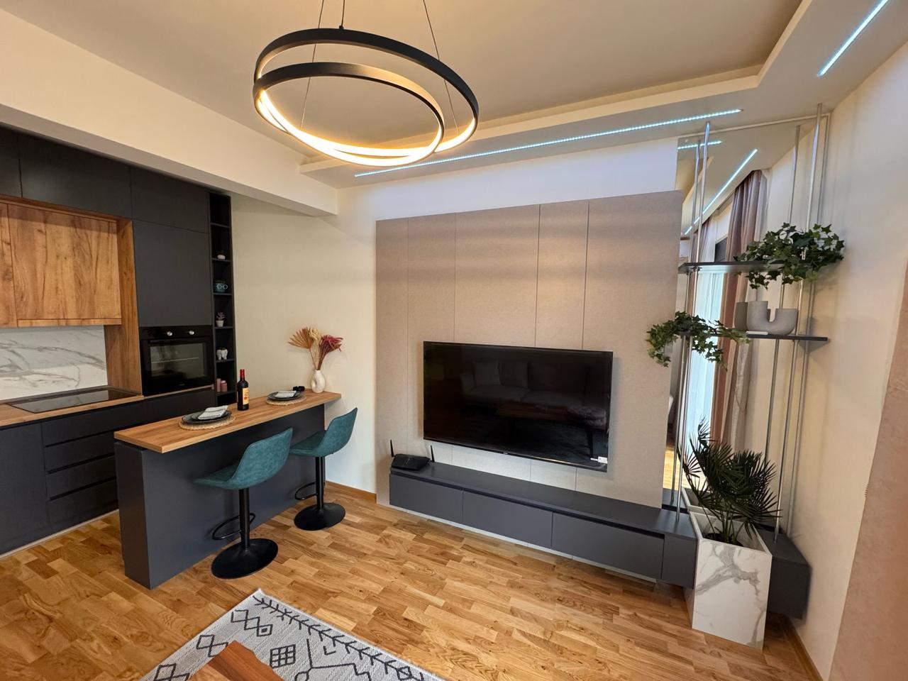 Stylish Ulcinj apartment with wood floors, island, teal barstools & sleek kitchen&mdash;investment on montenegro-listings.me by ekosphere doo.