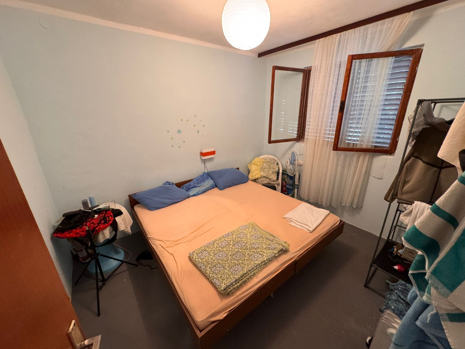 Charming Ulcinj bedroom with double bed, blue pillows, airy window&mdash;ideal real estate investment via montenegro-listings.me by ekosphere doo.