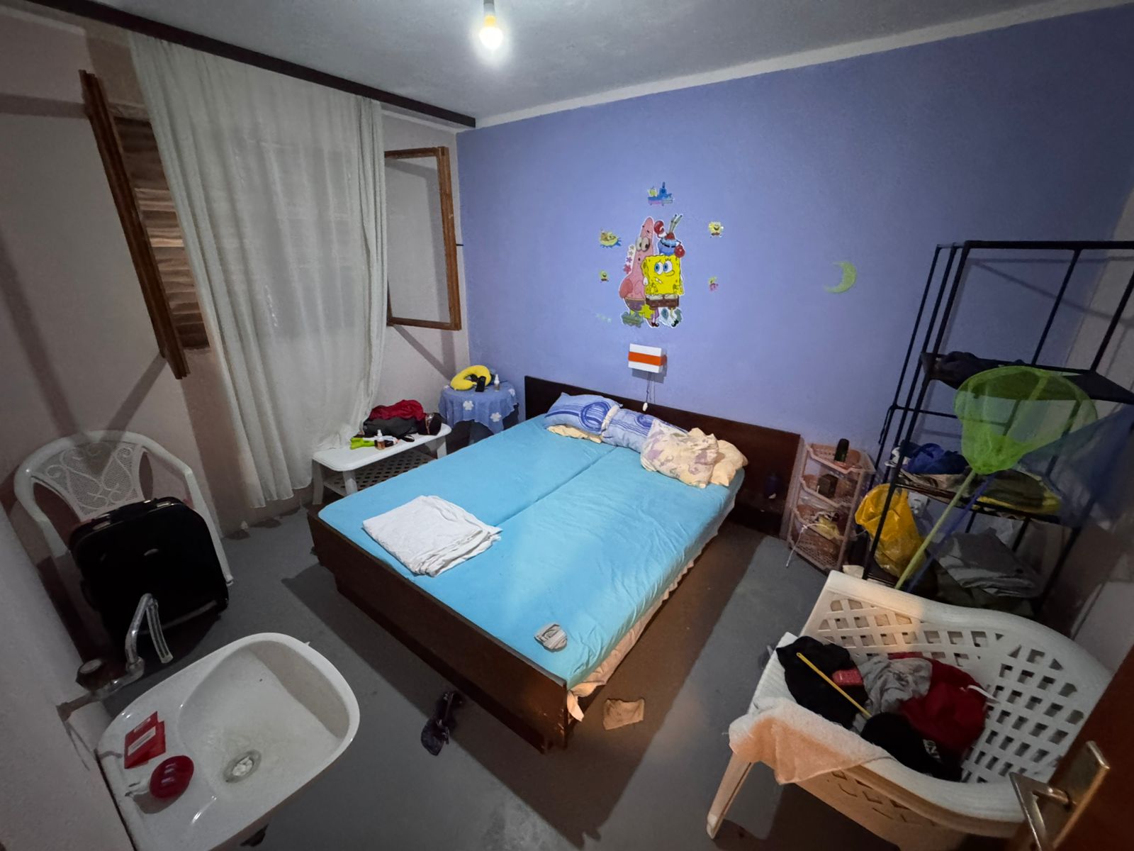 Contemporary Ulcinj bedroom with blue accents, double bed, open window. Invest in Montenegro real estate at montenegro-listings.me.