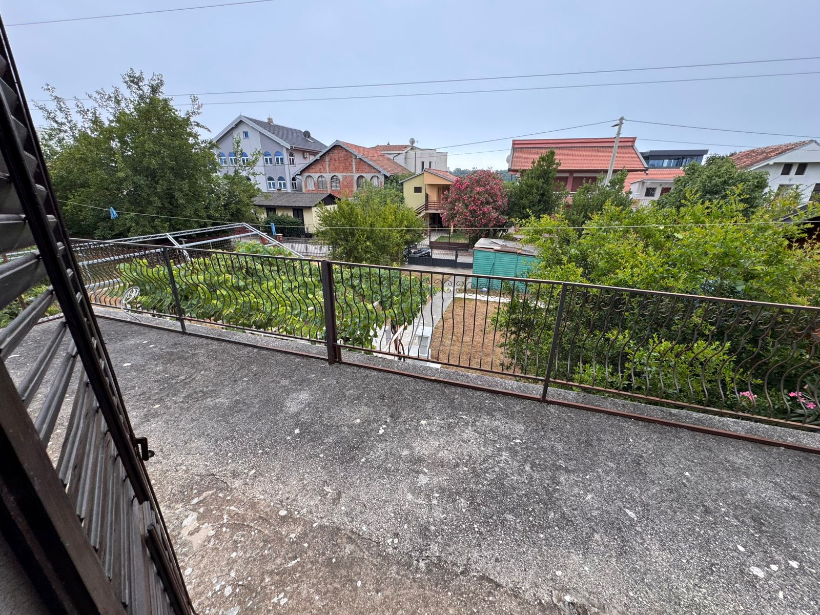 Stunning balcony view over lush fenced garden, sheds & prime Ulcinj properties&mdash;exclusive at montenegro-listings.me by Ekosphere doo.