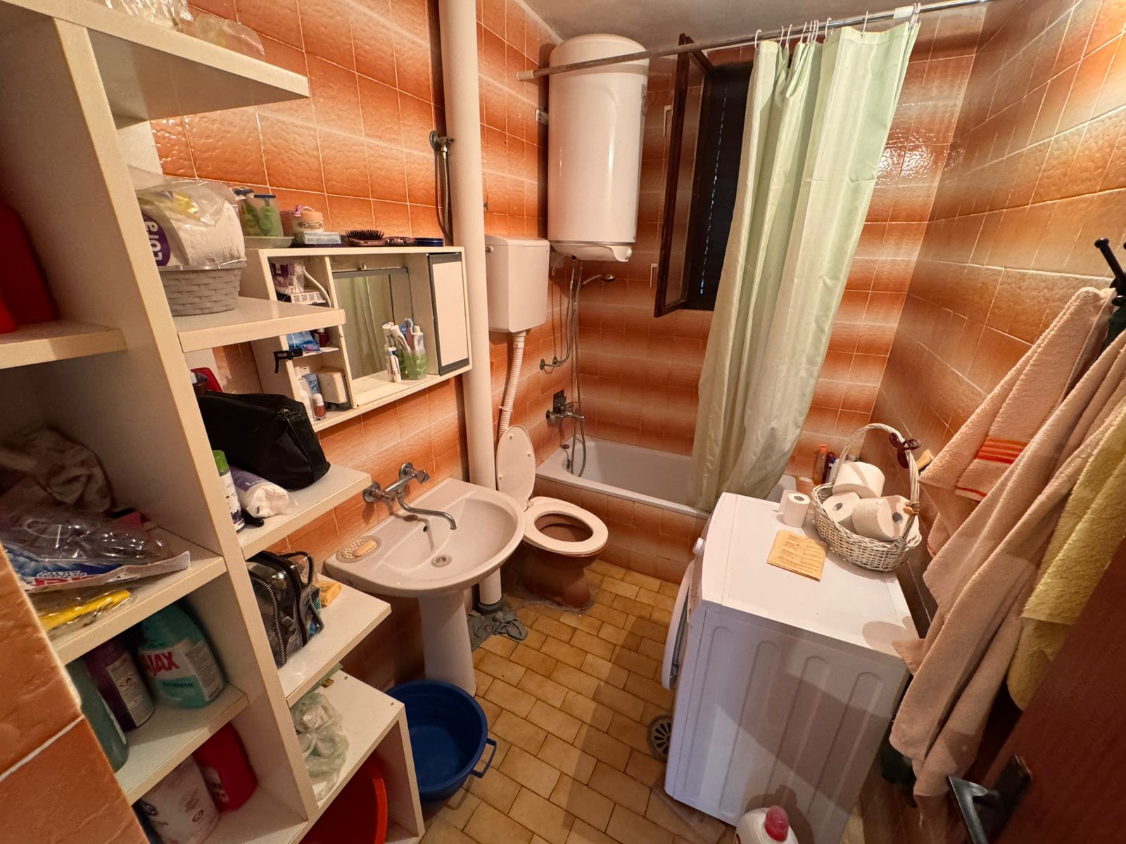 Modern Ulcinj bathroom with patterned tiles, tub, washing machine&mdash;ideal investment. Exclusive to montenegro-listings.me by ekosphere doo.