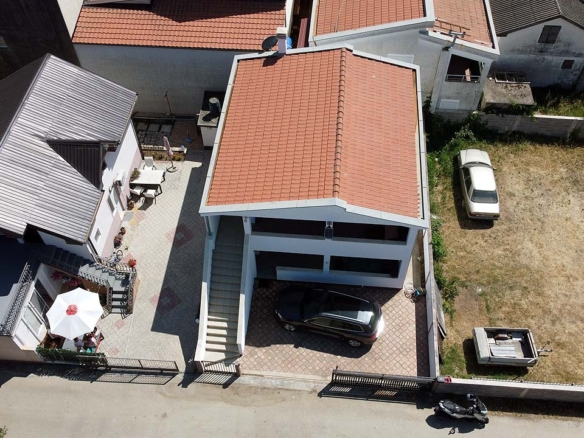 Prime investment opportunity in Ulcinj: two red-roofed homes, outdoor seating, parking, plus large lot—listed on montenegro-listings.me.