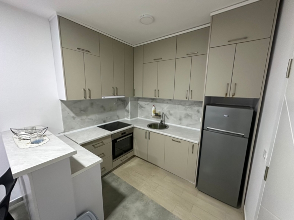 All Listings for Ulcinj: Elegant Ulcinj kitchen for sale: beige cabinets, built-in oven, stainless sink, modern appliances. Listed via montenegro-listings.me by ekosphere doo.