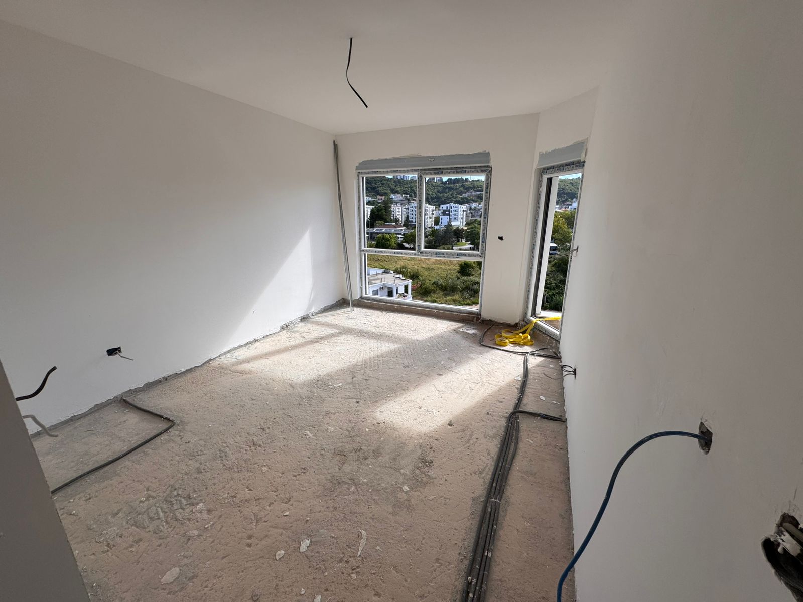 Bright unfinished room in Ulcinj by Ekosphere doo with large windows, city views—prime investment via montenegro-listings.me.