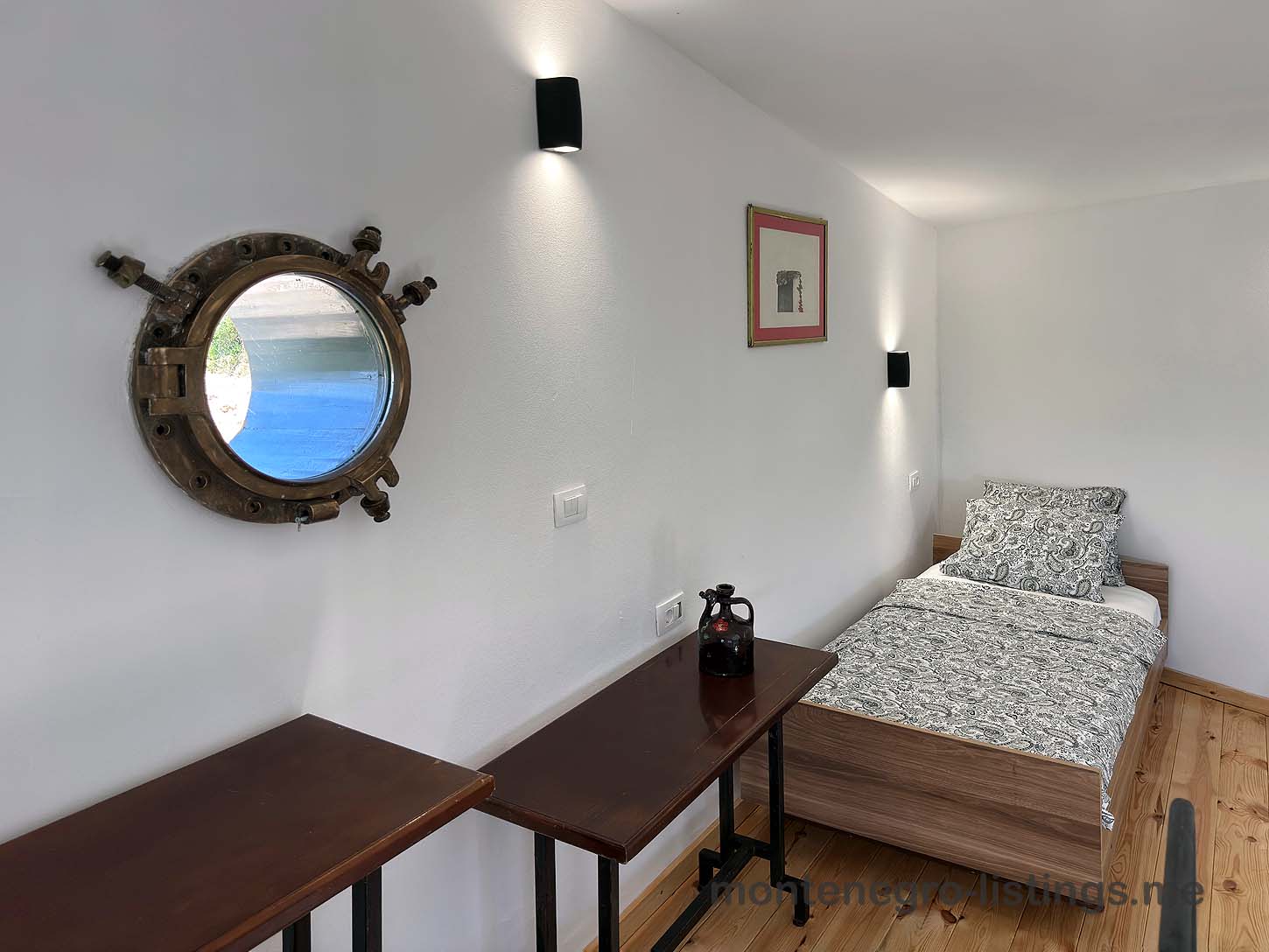 Charming Ulcinj bedroom for sale&mdash;wood floors, porthole window, stylish d&eacute;cor. Exclusive on montenegro-listings.me by Ekosphere.