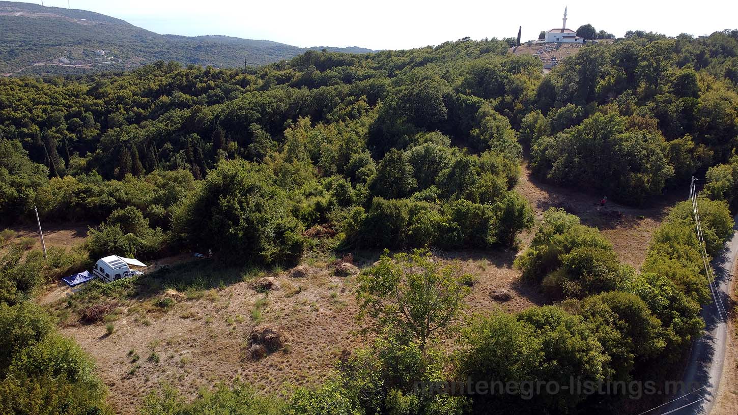 Aerial view of prime Ulcinj real estate&mdash;forest hills, road access, and ekosphere doo site. Invest with montenegro-listings.me today!.