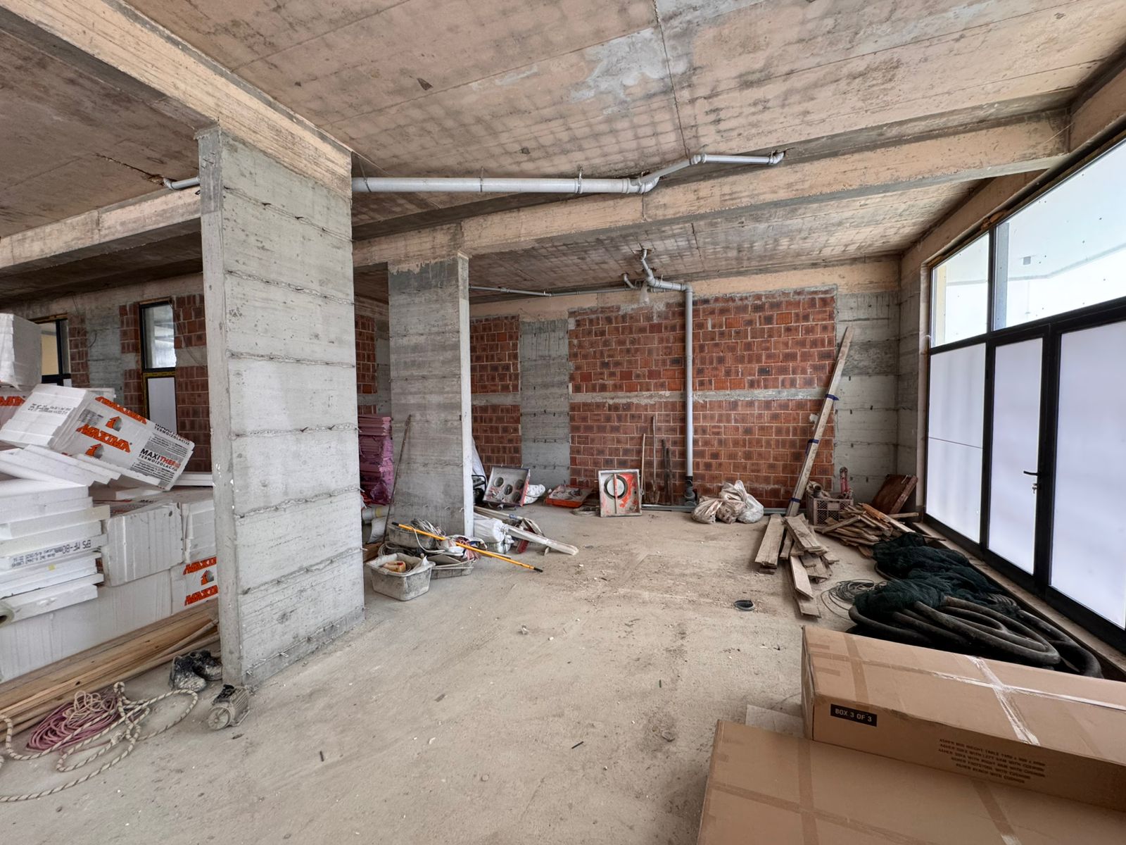Spacious unfinished property in Ulcinj, Montenegro&mdash;concrete floors, exposed brick, large windows&mdash;ideal real estate investment. Featured on montenegro-listings.me by Ekosphere doo.