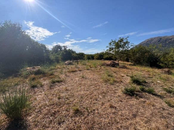 Prime Ulcinj, Montenegro land: sunny, open clearing with mountain views—top real estate investment via montenegro-listings.me by Ekosphere doo.