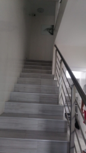 Modern staircase with light gray steps and sleek handrail, bright interior—premium Ulcinj property by montenegro-listings.me/Ekosphere doo.