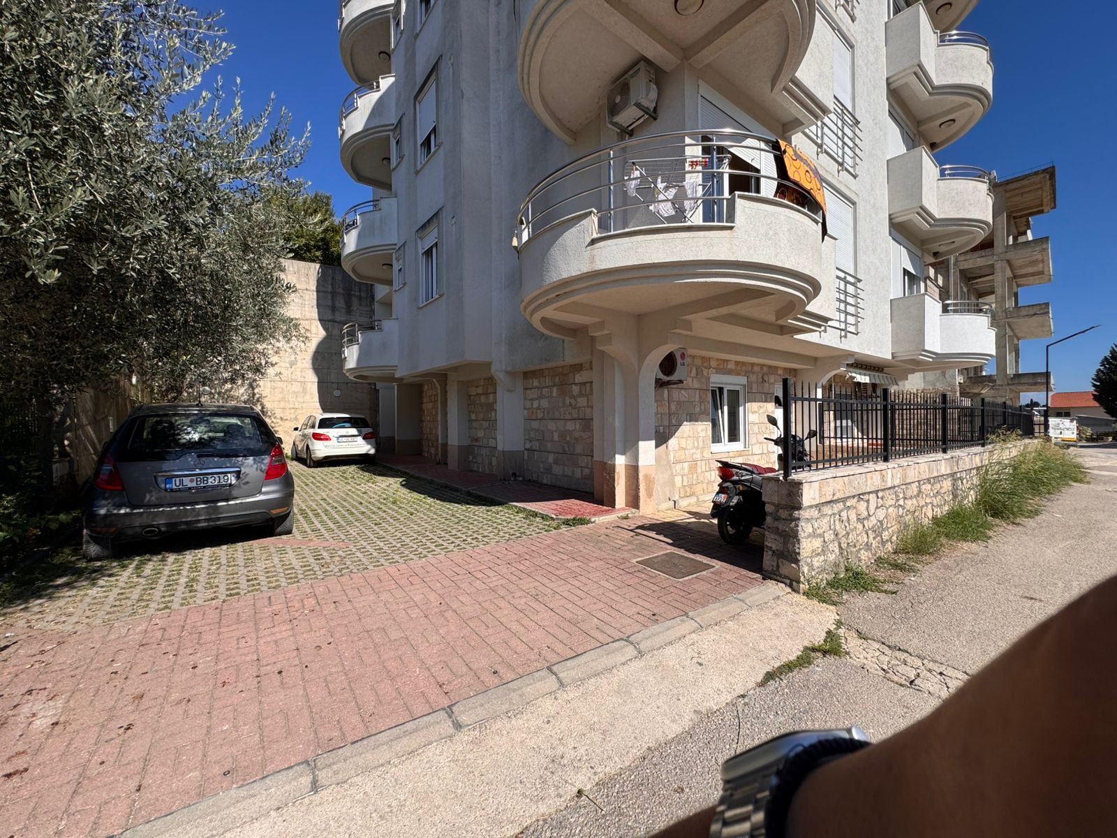 Modern multi-story Ulcinj apartment with curved balconies, tiled parking, and strong investment appeal at montenegro-listings.me.