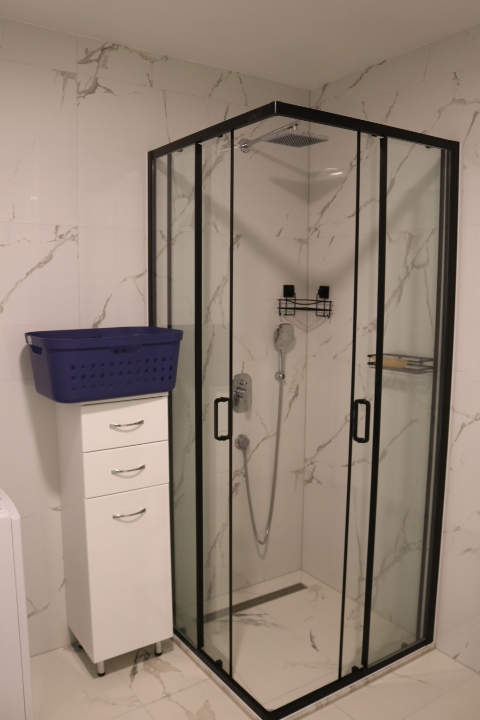 Discover a stylish Ulcinj bathroom with marble walls, glass shower, premium fixtures—exclusive at montenegro-listings.me by ekosphere doo.