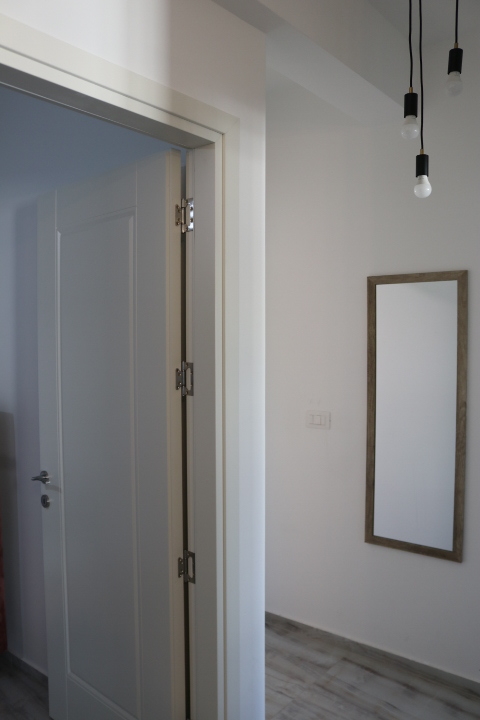 Step into this modern Ulcinj apartment: sleek gray wood floors, elegant lighting, and quality finishes. See more on montenegro-listings.me by ekosphere doo.