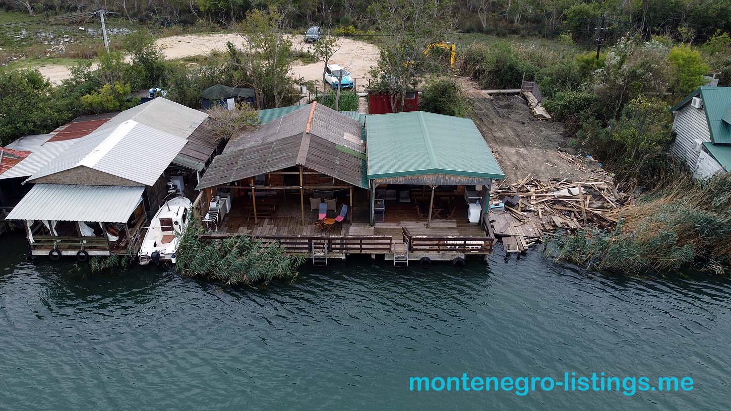 Exclusive aerial view of Ulcinj waterfront homes with private boat docks, lush nature, and investment potential at montenegro-listings.me.