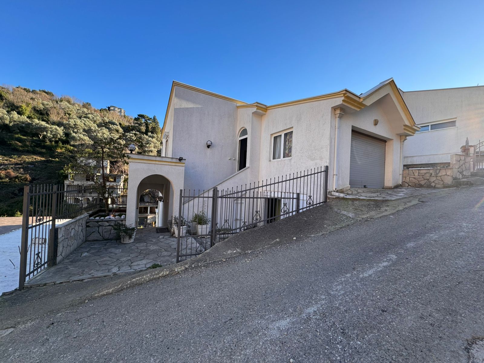 Charming white single-story home in Ulcinj, Montenegro, with patio, garage, gated entry&mdash;prime investment via montenegro-listings.me.