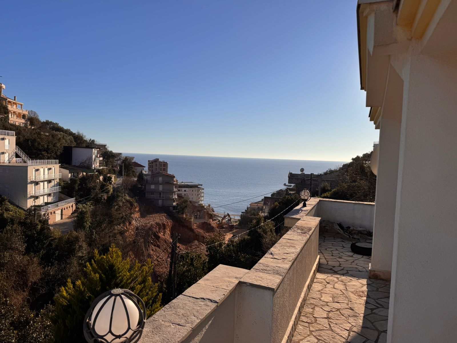 Premium terrace with elegant stone flooring, panoramic sea view, hillside homes, and lush greenery&mdash;ideal Ulcinj investment. Montenegro-listings.me by ekosphere doo.
