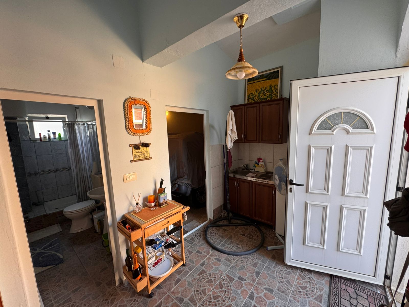 Bright entryway with tiled floors, modern white door, bathroom access, and versatile storage&mdash;ideal Ulcinj investment via montenegro-listings.me.