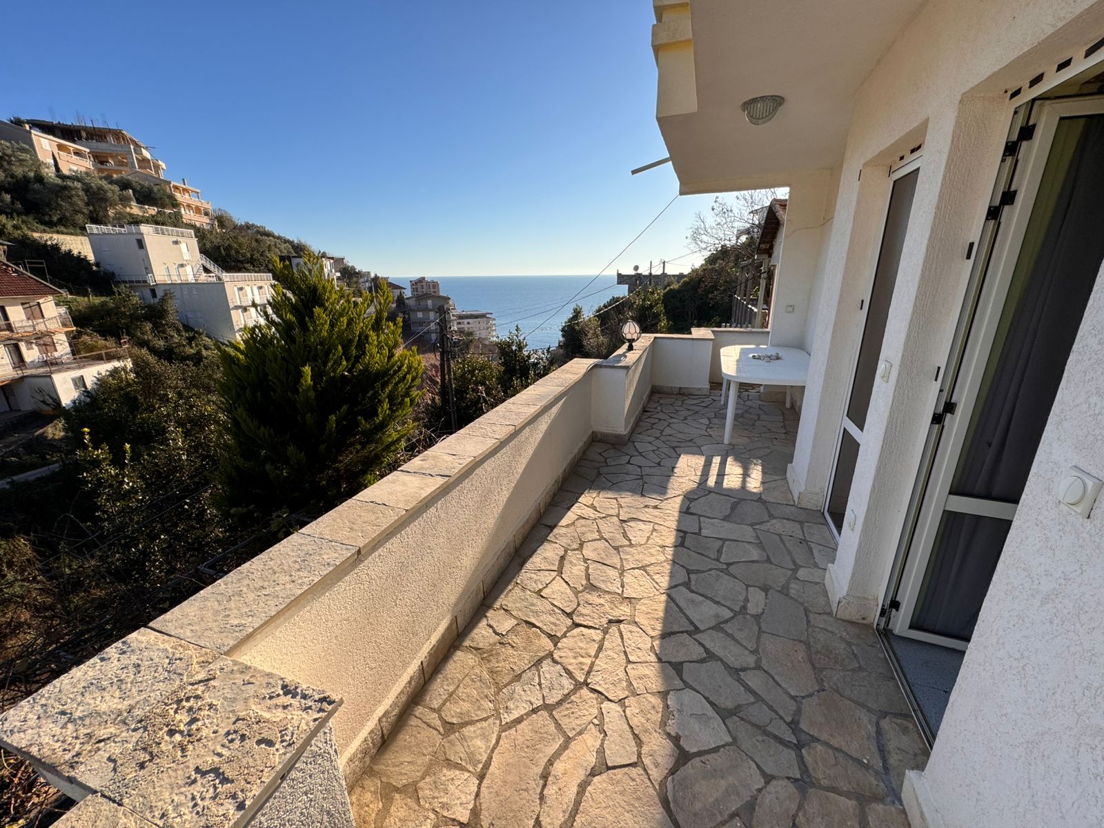 Experience Ulcinj luxury: stone-tiled balcony, panoramic sea views, lush hills, prime real estate by ekosphere doo via montenegro-listings.me.