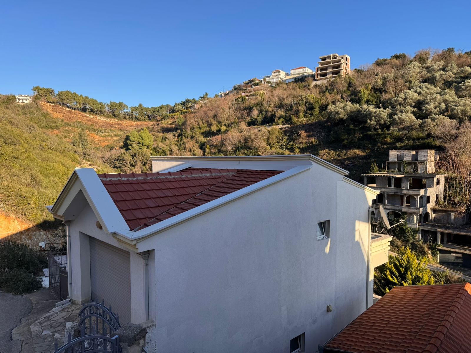 Charming white house with red-tiled roof in Ulcinj, overlooking lush hills&mdash; prime Montenegro property on montenegro-listings.me by ekosphere doo.