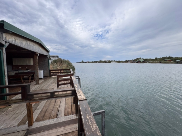 Stunning waterfront deck in Ulcinj, Montenegro—ideal investment with serene views, benches, and close to shoreline homes. Listed by ekosphere doo.