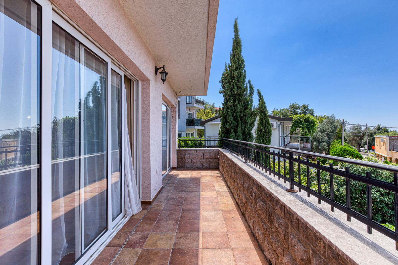 Spacious tiled balcony with metal railing, large glass doors, and scenic Ulcinj views&mdash;prime property via montenegro-listings.me by ekosphere doo.