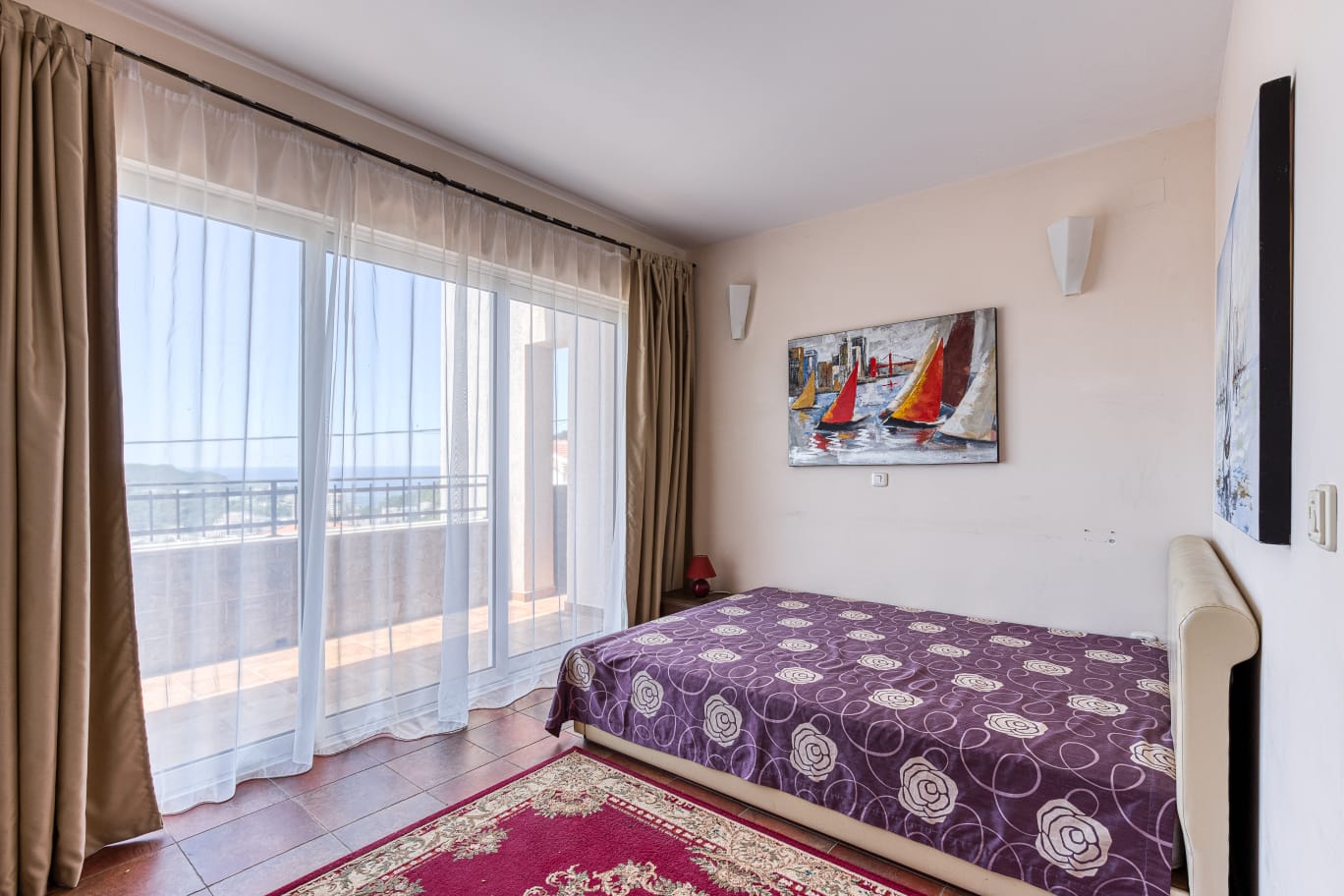 Spacious Ulcinj bedroom with natural light, balcony access, stylish d&eacute;cor. Invest in Montenegro real estate at montenegro-listings.me.