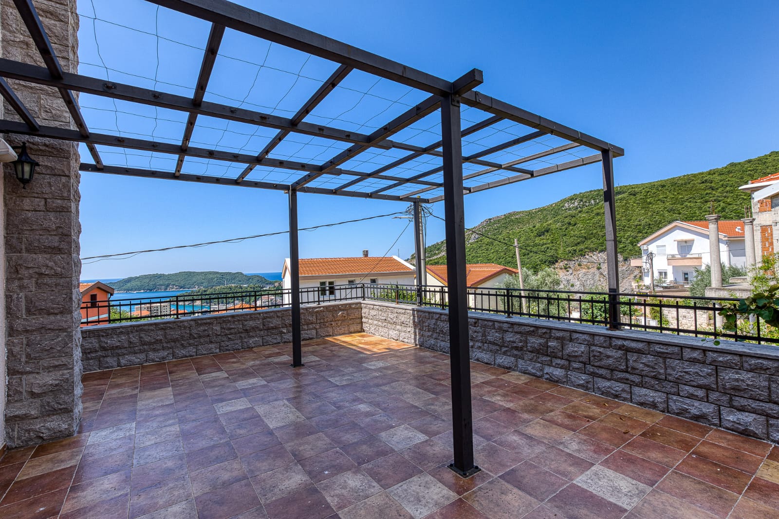 Experience luxury living on this expansive tiled terrace, boasting sea and green hill views in Ulcinj. Exclusive at montenegro-listings.me by ekosphere doo.