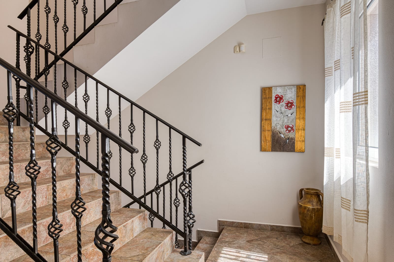 Elegant staircase with designer iron railings, sunlit windows, and tasteful decor&mdash;ideal Ulcinj investment. Montenegro-listings.me by ekosphere doo.