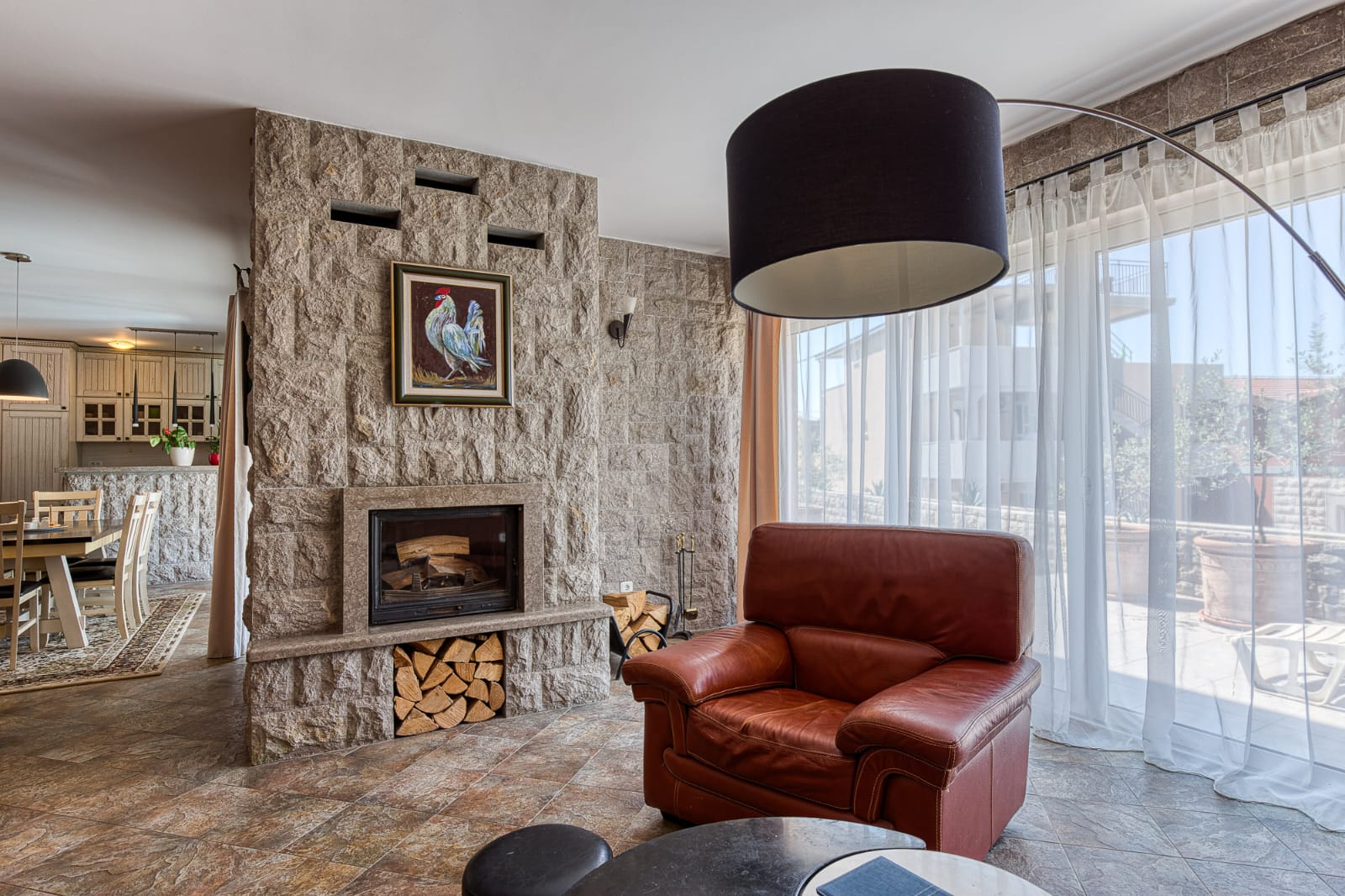 Elegant Ulcinj living room: stone fireplace, large windows, premium finishes. Exclusive on montenegro-listings.me by ekosphere doo.