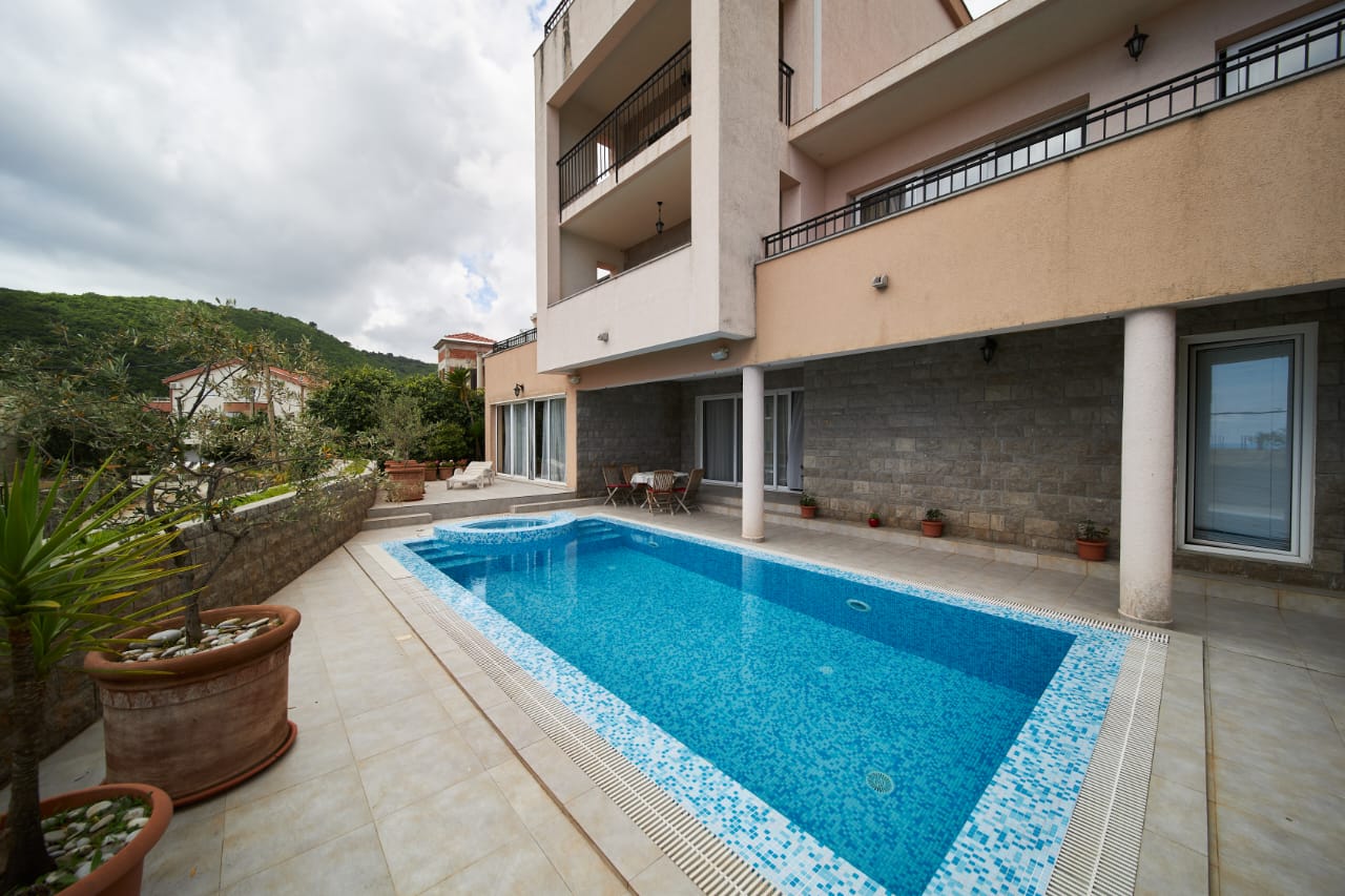 Luxury residential property in Ulcinj with pool, balconies, potted plants, and hill views&mdash;exclusive at montenegro-listings.me by ekosphere doo.