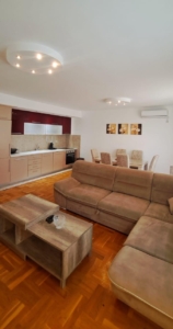 Stunning Ulcinj apartment: open-plan living, modern kitchen, AC, stylish dining—prime Montenegro property. On montenegro-listings.me by ekosphere doo.