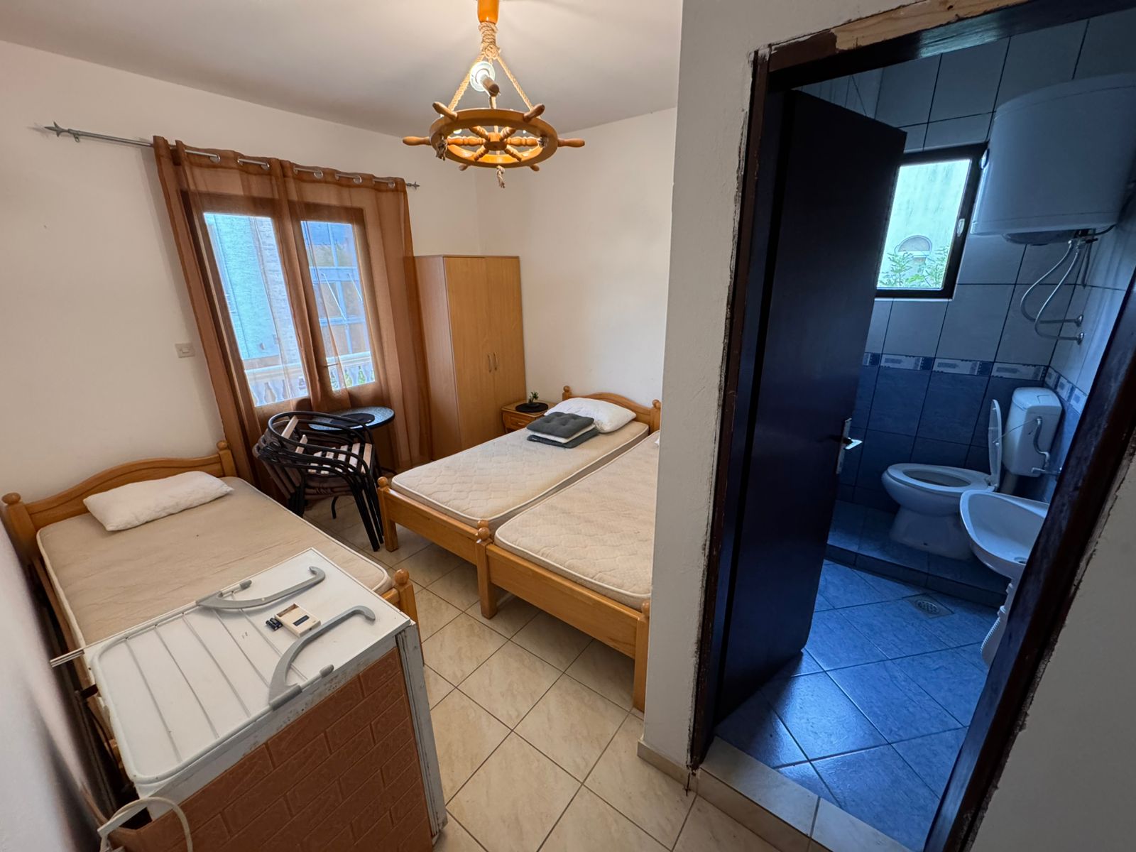 Bright hotel room in Ulcinj with 2 single beds, extra bed, wood furniture, private bath; prime investment via montenegro-listings.me.