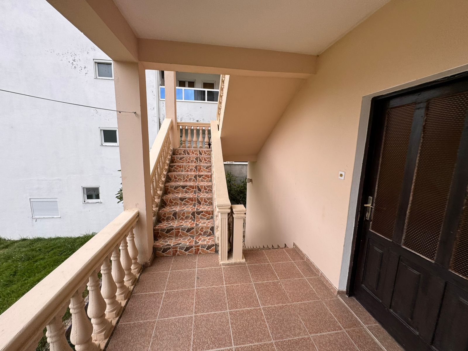 Stylish Ulcinj property: elegant tiled entry, premium wood door, designer staircase, garden views. Invest at montenegro-listings.me by ekosphere doo.